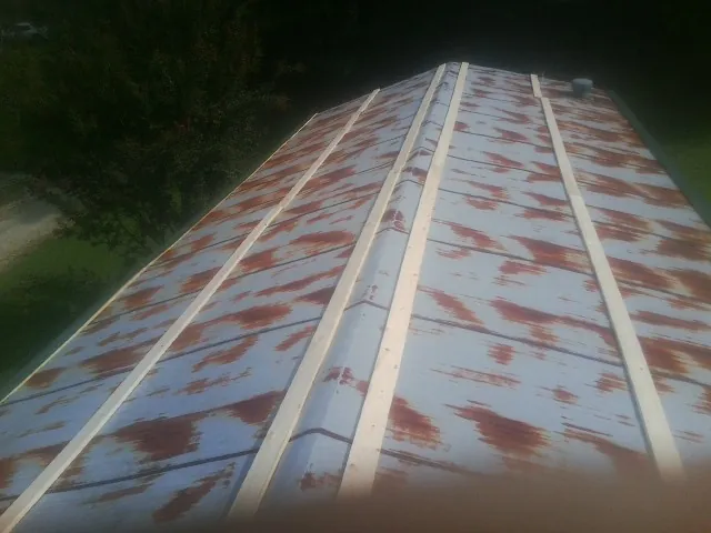 Rusted metal roof panels with new wood purlins before replacement — Storm Damage Roof Repair in Pine Plains by Roofing Brothers