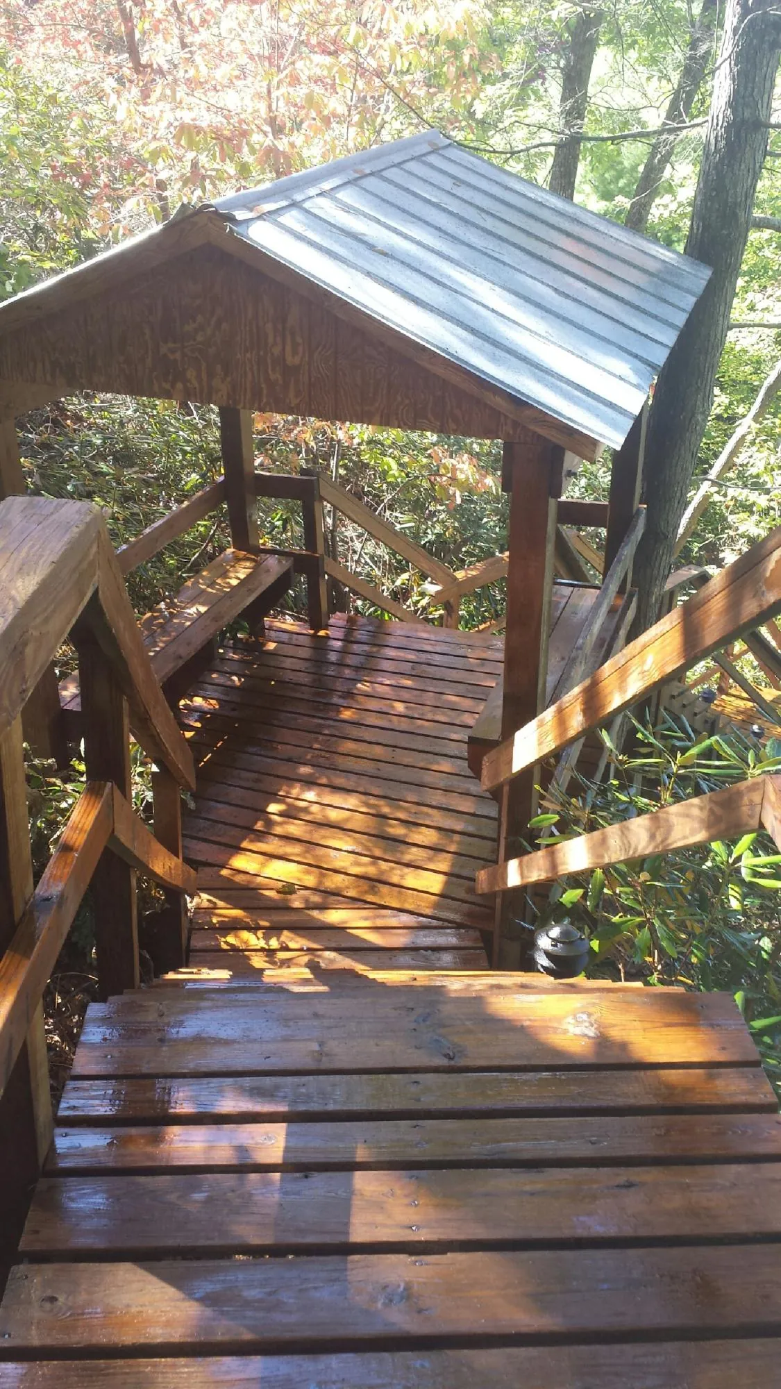 Freshly stained wood walkway and covered shelter with a metal roof in Pine Plains