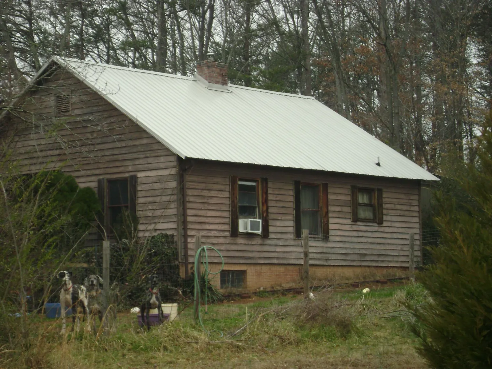 White metal roof on an old wood sided farmhouse, from a Asphalt Shingle Roof Repair job in Pine Plains
